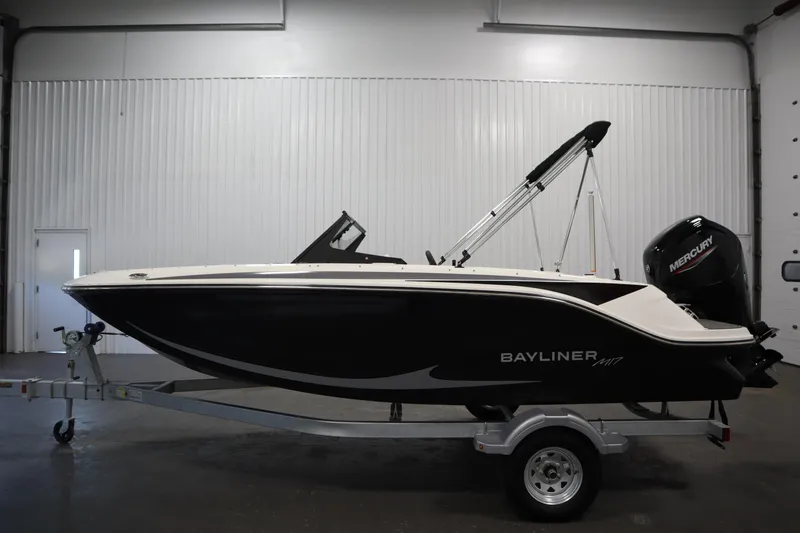 Slide: The Image of 2025 Bayliner M17 Element MX Comfort boat on trailer in indoor setting. - 9