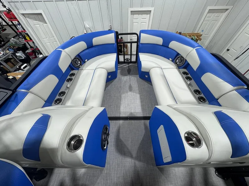Slide: The Image of Interior of 2025 Montara Surf Boss boat with blue and white seating at Dallas Boathouse. - 15