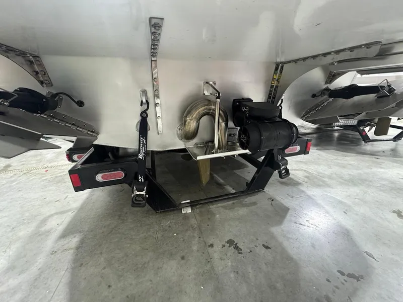 Slide: The Image of 2025 Montara Surf Boss boat in showroom, rear view with spiral staircase. - 3