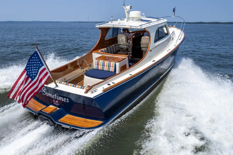 Slide: The Image of 2007 Hinckley Picnic Boat EP cruising on open water with American flag. - 1