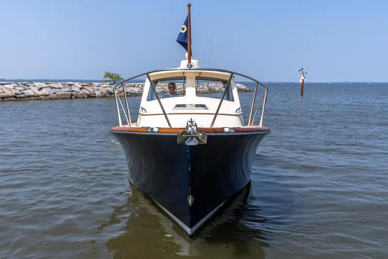 Slide: The Image of 2007 Hinckley Picnic Boat EP on calm water, front view. - 11