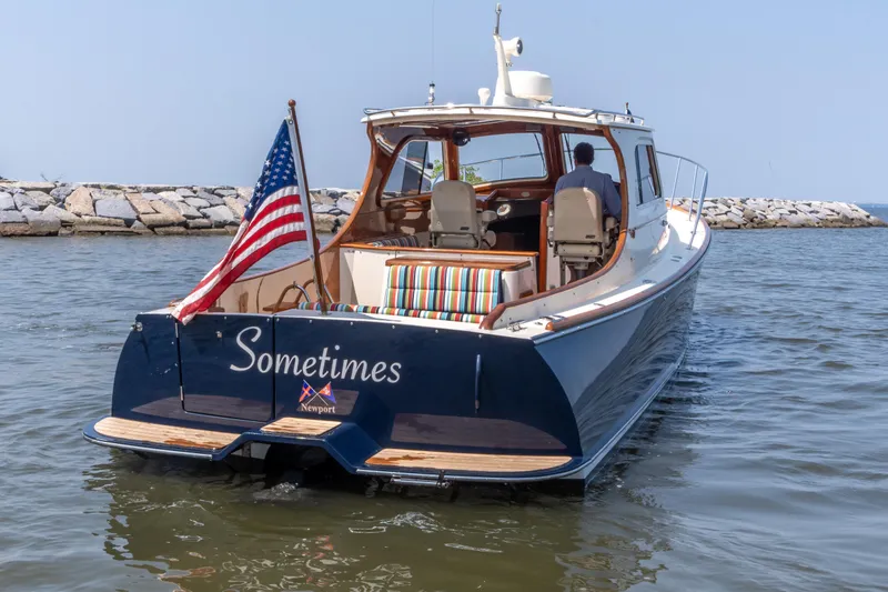 Slide: The Image of 2007 Hinckley Picnic Boat EP cruising with American flag, named "Sometimes," in a serene harbor setting. - 13
