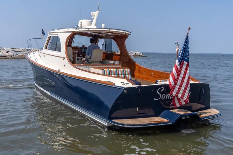 Slide: The Image of 2007 Hinckley Picnic Boat EP cruising on calm waters with American flag. - 15