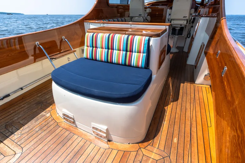 Slide: The Image of 2007 Hinckley Picnic Boat EP interior with striped cushions and wooden deck. - 22