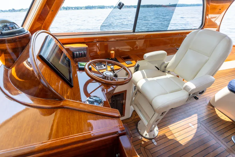 Slide: The Image of Luxurious 2007 Hinckley Picnic Boat EP helm with polished wood and leather seating. - 33