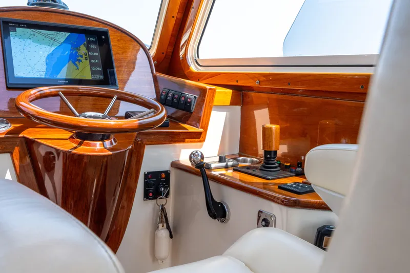 Slide: The Image of 2007 Hinckley Picnic Boat EP helm with wooden steering wheel and navigation display. - 34