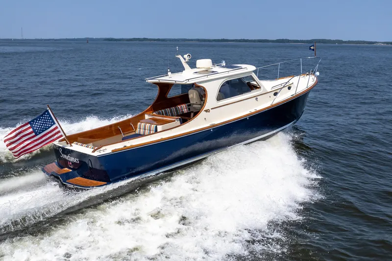 Slide: The Image of 2007 Hinckley Picnic Boat EP cruising on open water with American flag. - 4