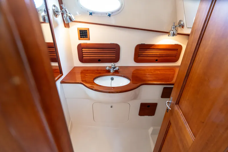 Slide: The Image of Luxurious 2007 Hinckley Picnic Boat EP bathroom with wooden accents and modern fixtures. - 44