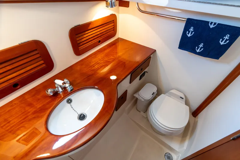 Slide: The Image of 2007 Hinckley Picnic Boat EP bathroom with wooden countertop, sink, and toilet. - 45