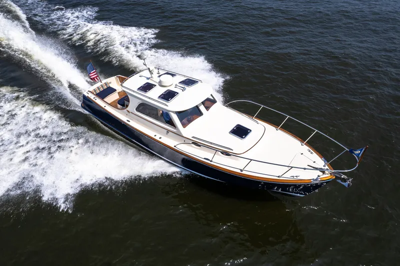 Slide: The Image of 2007 Hinckley Picnic Boat EP cruising on open water, showcasing elegant design and performance. - 7