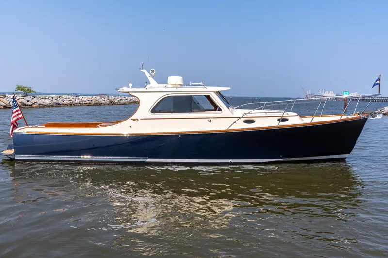 Slide: The Image of 2007 Hinckley Picnic Boat EP on calm water, showcasing elegant design and craftsmanship. - 9