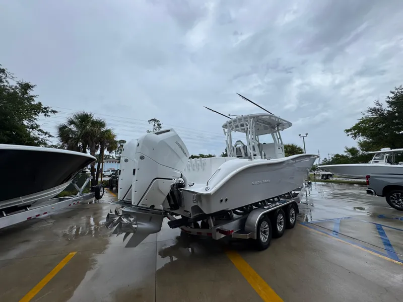 Slide: The Image of 2025 Cape Horn 32 XS boat on trailer in parking lot, overcast sky. - 11