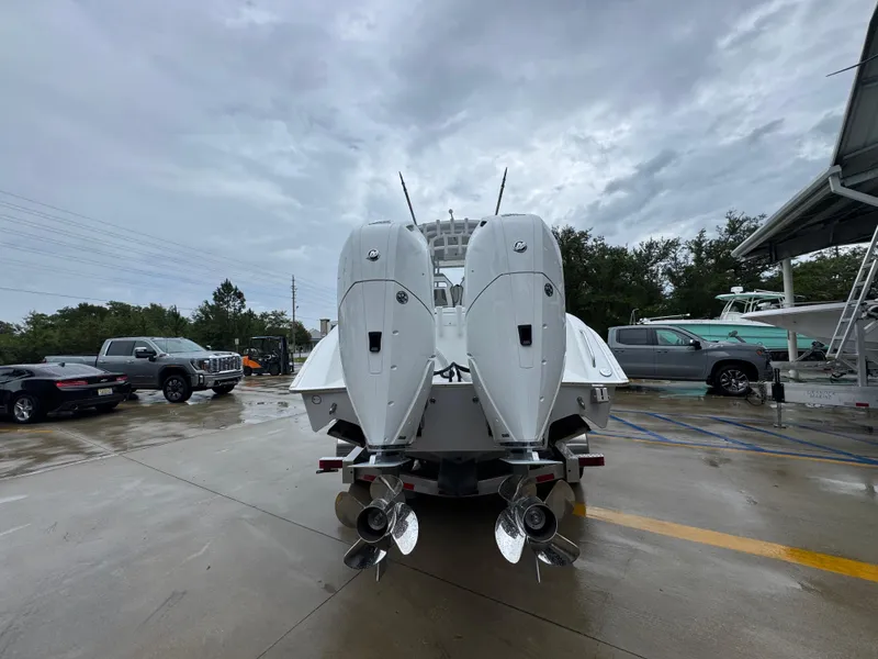 Slide: The Image of 2025 Cape Horn 32 XS boat with dual outboard motors in a parking lot. - 13