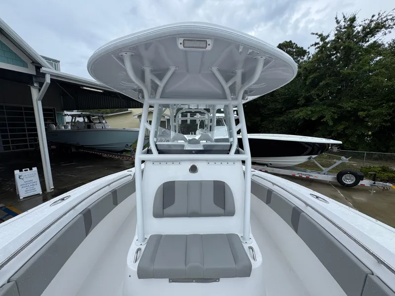 Slide: The Image of 2025 Cape Horn 32 XS boat with sleek design, parked outdoors under cloudy sky. - 24