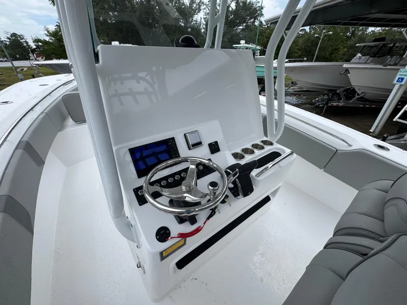 Slide: The Image of 2025 Cape Horn 32 XS boat console with steering wheel and controls. - 28