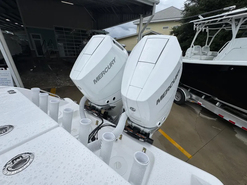 Slide: The Image of 2025 Cape Horn 32 XS with dual Mercury outboard engines in a marina setting. - 38