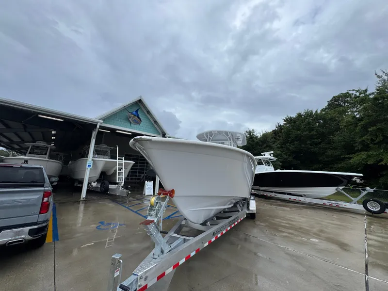 Slide: The Image of 2025 Cape Horn 32 XS boat on trailer at dealership, cloudy sky background. - 5