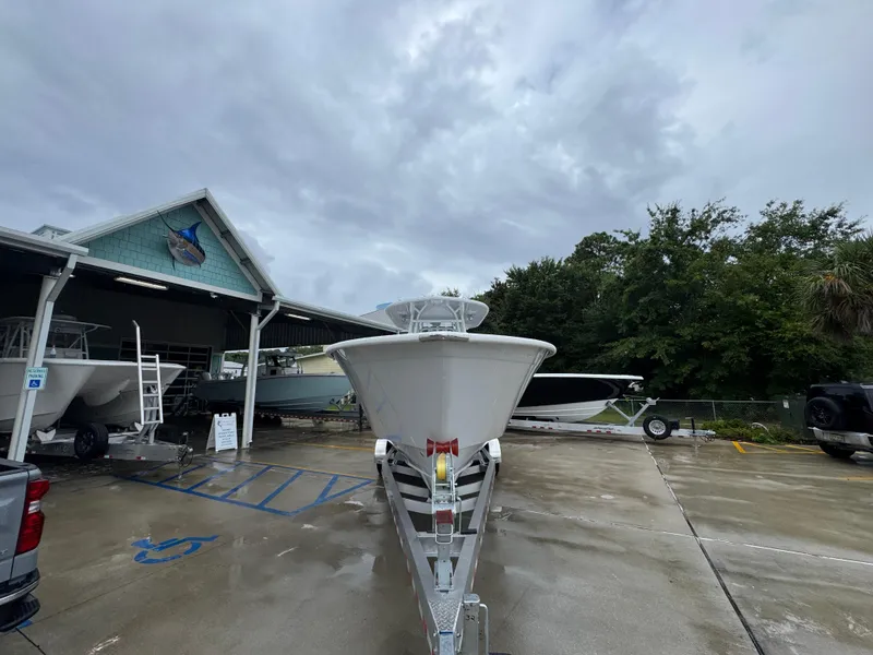 Slide: The Image of 2025 Cape Horn 32 XS boat on trailer outside a marine dealership. - 6