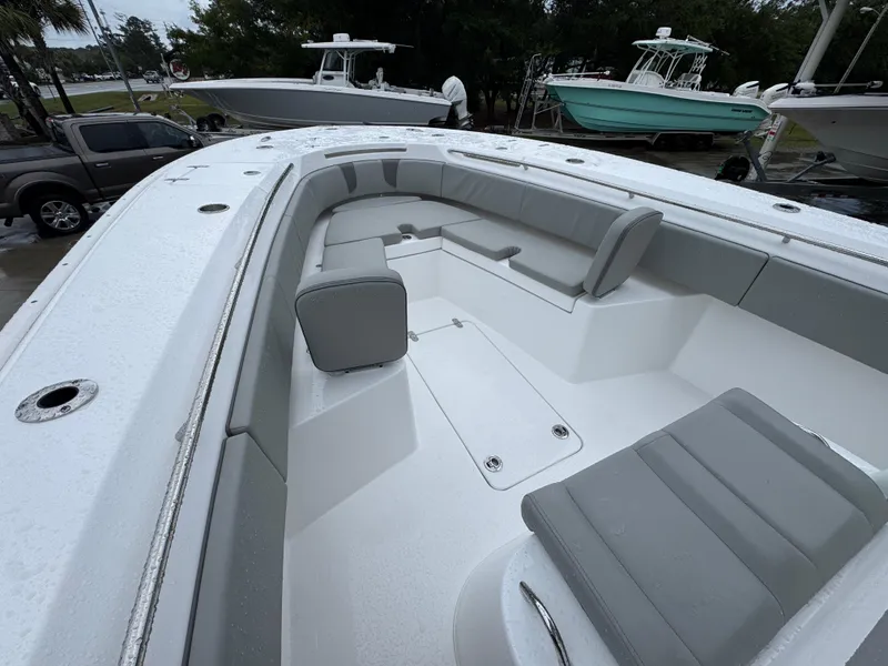Slide: The Image of 2025 Cape Horn 32 XS boat interior with gray seating and sleek design. - 19