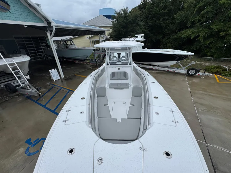 Slide: The Image of 2025 Cape Horn 32 XS boat displayed at a dealership, showcasing sleek design and spacious seating. - 21