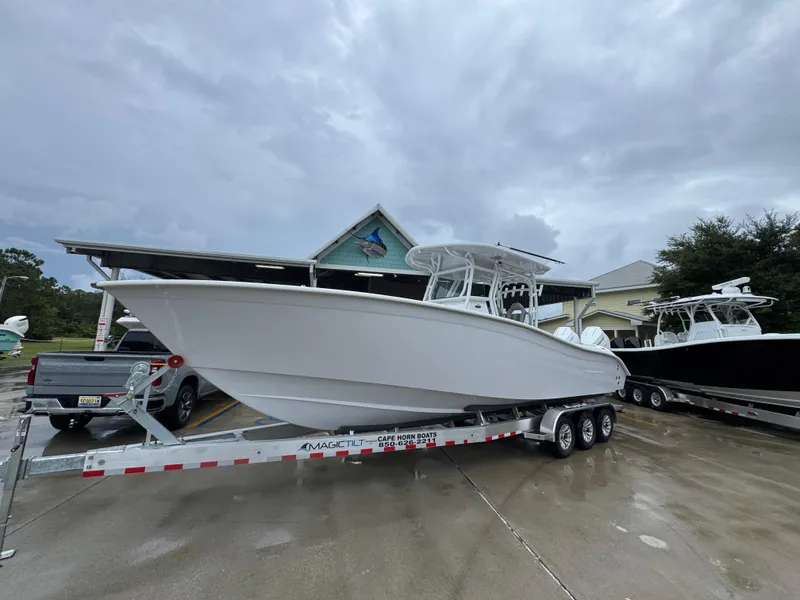 Slide: The Image of 2025 Cape Horn 32 XS boat on trailer, parked outdoors near a building. - 3