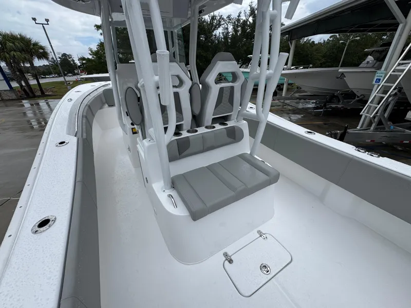 Slide: The Image of 2025 Cape Horn 32 XS boat interior with seating and console, docked outdoors. - 34