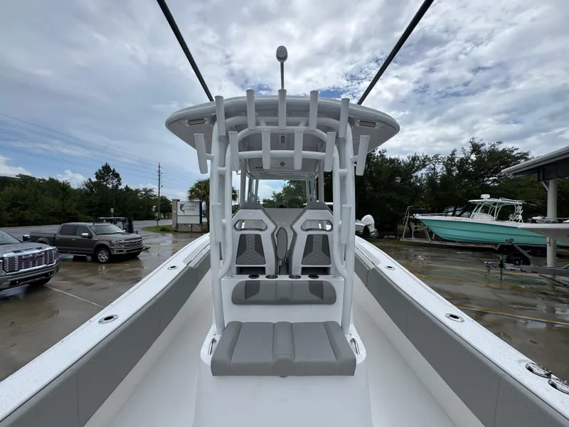 Slide: The Image of 2025 Cape Horn 32 XS boat interior with seating, parked outdoors on a cloudy day. - 35