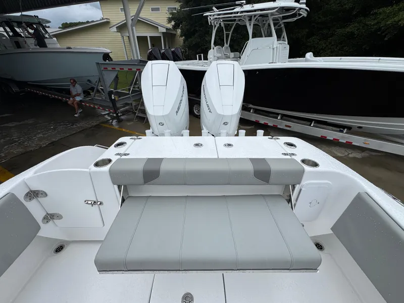 Slide: The Image of 2025 Cape Horn 32 XS boat with dual Mercury engines and cushioned seating. - 37