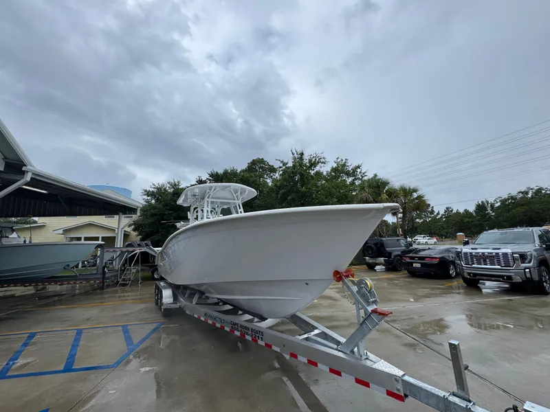 Slide: The Image of 2025 Cape Horn 32 XS boat on trailer in parking lot, cloudy sky background. - 7