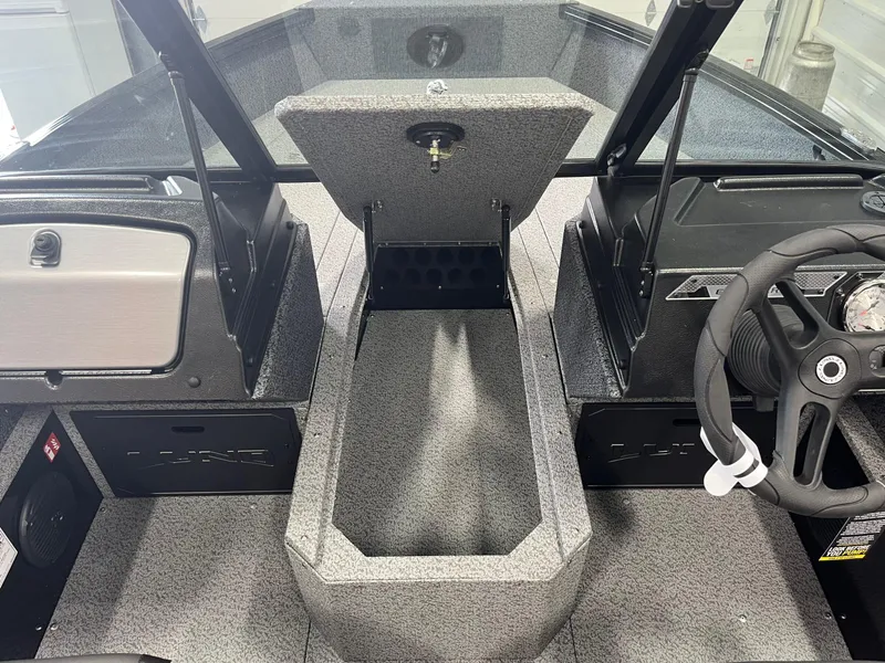 Slide: The Image of 2026 Lund 1800 Explorer Sport interior with open storage compartment and steering wheel. - 10