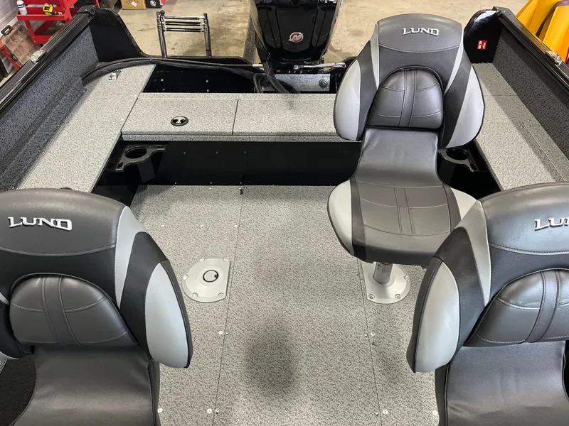 Slide: The Image of 2026 Lund 1800 Explorer Sport boat interior with gray seating and deck. - 11