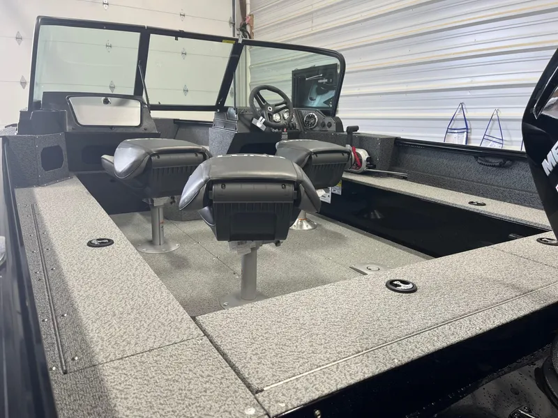 Slide: The Image of 2026 Lund 1800 Explorer Sport boat interior with dual seats and modern dashboard. - 7