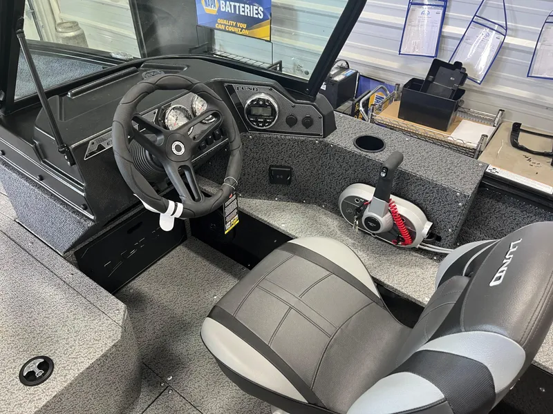 Slide: The Image of 2026 Lund 1800 Explorer Sport boat interior with steering wheel and control panel. - 8
