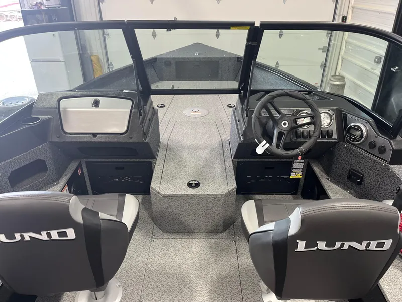 Slide: The Image of 2026 Lund 1800 Explorer Sport boat interior with steering wheel and seating. - 9