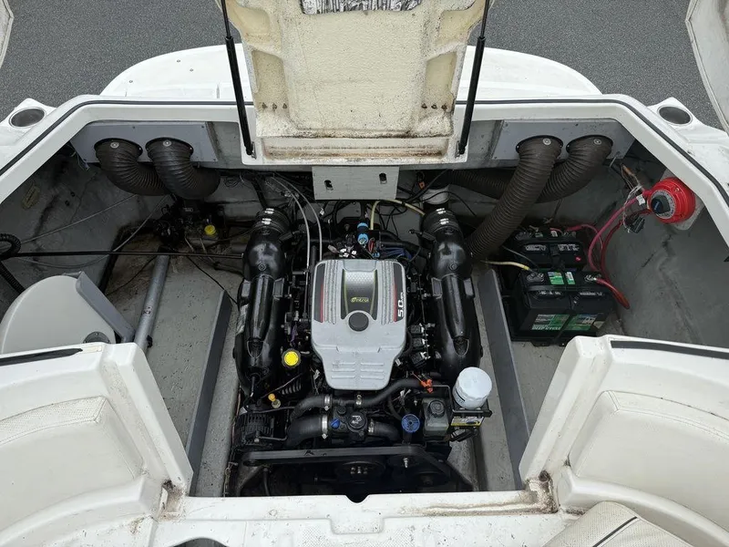 Slide: The Image of Engine compartment of a 2012 Bayliner 235 BR boat, showcasing the engine and battery setup. - 10