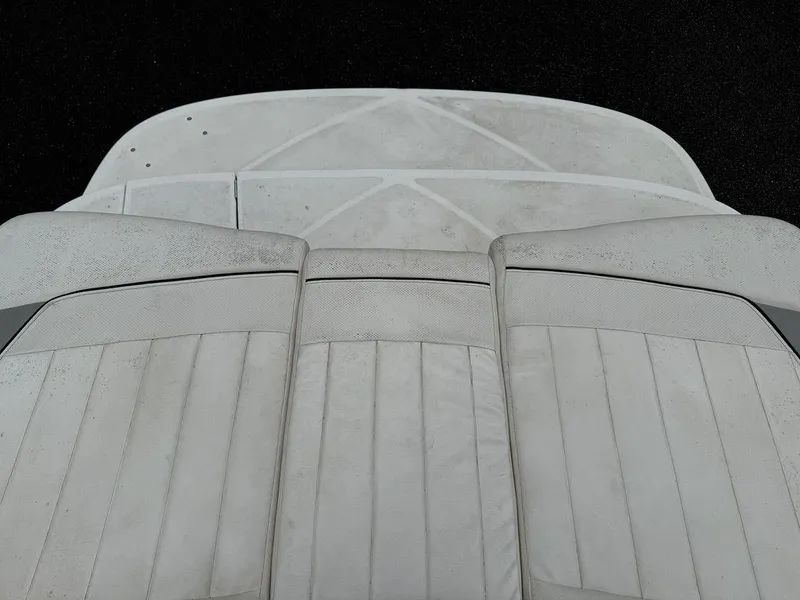 Slide: The Image of 2012 Bayliner 235 BR boat seating with white upholstery, viewed from above. - 13