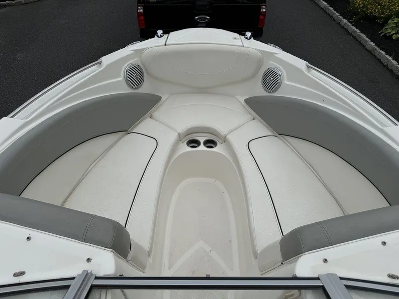 Slide: The Image of 2012 Bayliner 235 BR boat interior with cushioned seating and cup holders. - 15