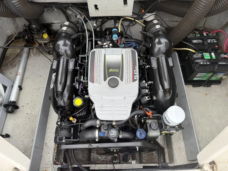 Slide: The Image of Engine compartment of a 2012 Bayliner 235 BR boat, featuring a MerCruiser 5.0 MPI engine. - 17