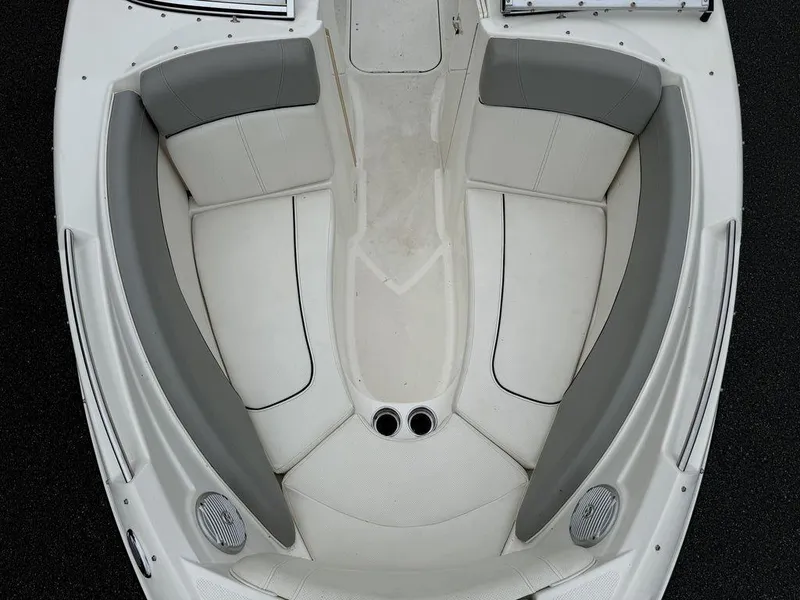 Slide: The Image of 2012 Bayliner 235 BR boat interior with gray and white seating, top view. - 6