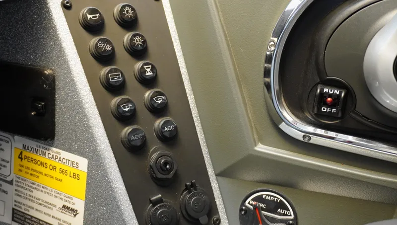 Slide: The Image of Control panel of 2024 Ranger Z518 Ranger Cup Equipped boat with switches and capacity label. - 13