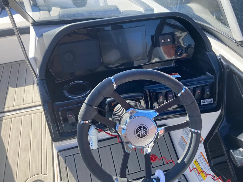 Slide: The Image of 2024 Yamaha Boats 195S dashboard with steering wheel and control panel. - 11