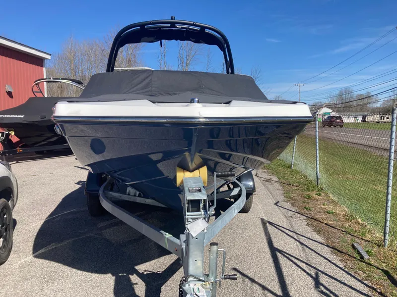 Slide: The Image of 2024 Yamaha Boats 195S on trailer, parked outdoors under clear blue sky. - 2