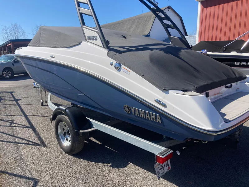 Slide: The Image of 2024 Yamaha Boats 195S on trailer, covered, parked outdoors. - 3