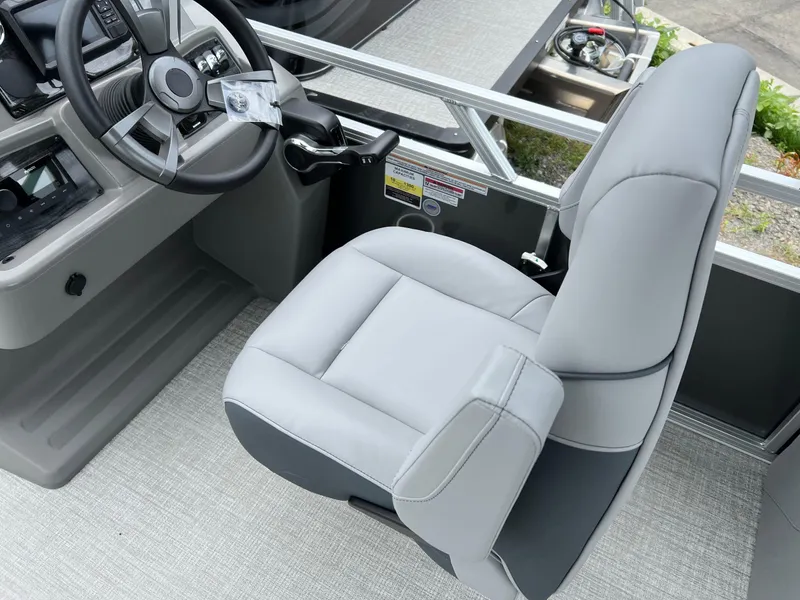 Slide: The Image of Captain's chair and steering console of 2026 Tahoe Pontoon 2180 boat. - 13