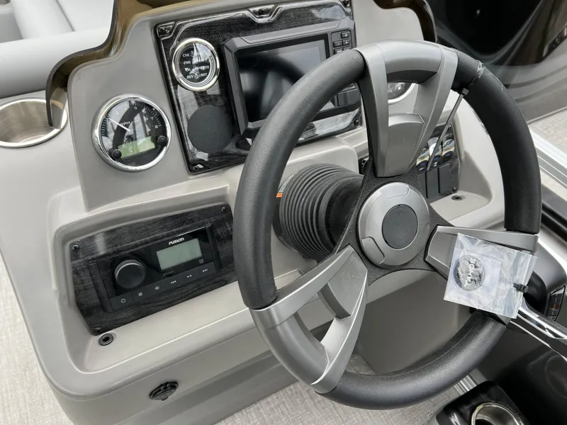 Slide: The Image of Steering console of 2026 Tahoe Pontoon 2180 with modern controls and gauges. - 14