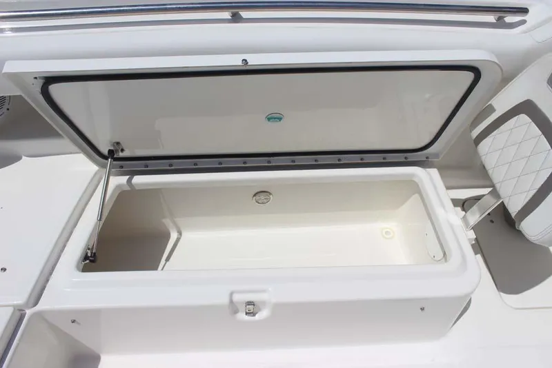 Slide: The Image of Open storage compartment on 2023 World Cat 280 CC-X boat, featuring sleek design and ample space. - 12