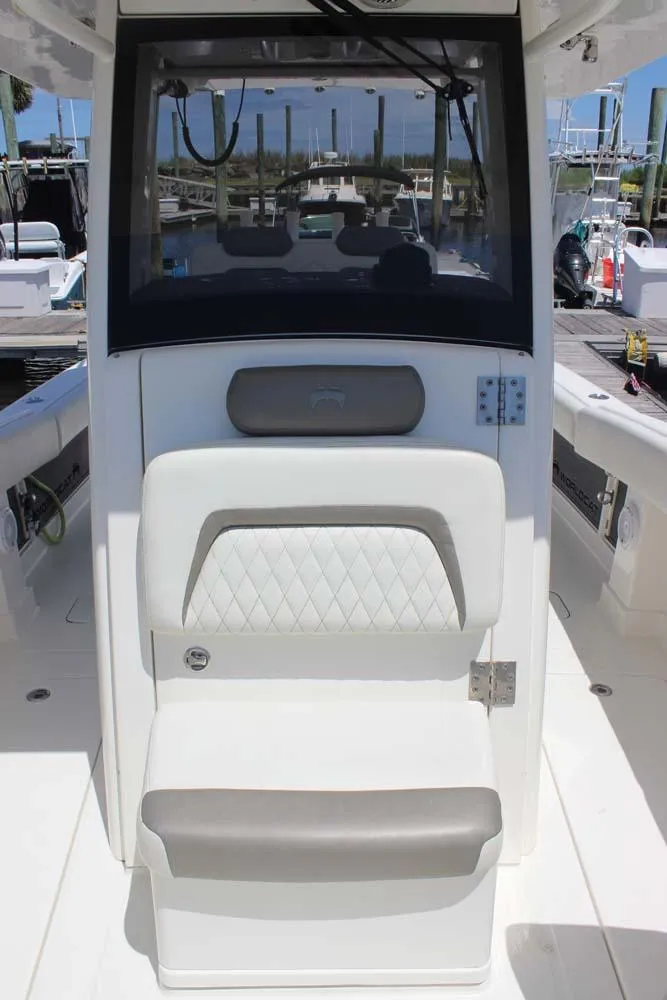 Slide: The Image of 2023 World Cat 280 CC-X boat interior with cushioned seating and helm station. - 13