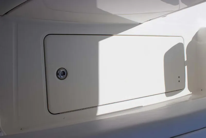 Slide: The Image of 2023 World Cat 280 CC-X storage compartment with secure latch, partially shaded. - 16