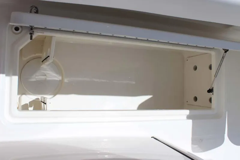 Slide: The Image of 2023 World Cat 280 CC-X storage compartment, open lid, white interior, marine design. - 17