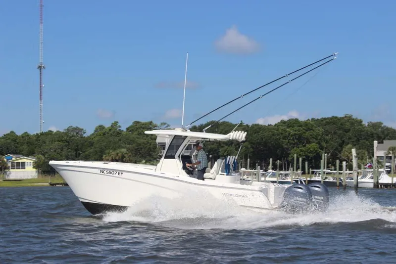 Slide: The Image of 2023 World Cat 280 CC-X boat cruising on water with dual engines. - 2